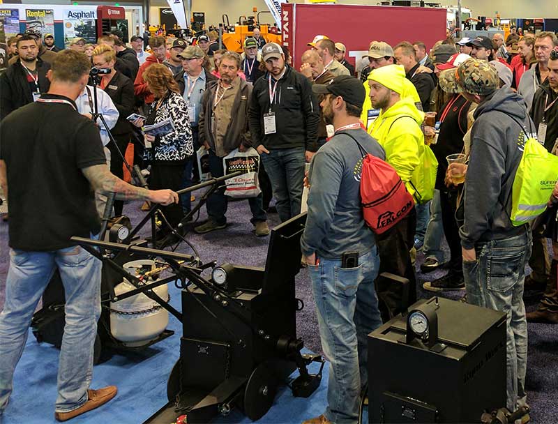 Judd Burdon demonstrating the RY10 Pro Crack Fill Machine at the National Pavement Expo in 2017